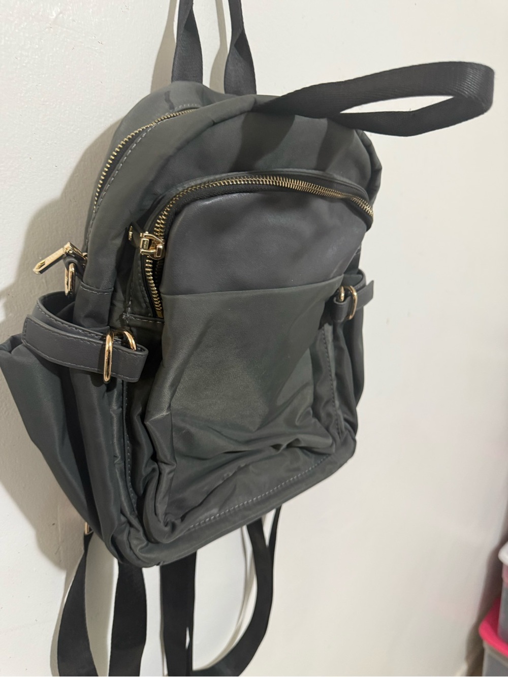 Compact Gray Backpack with Gold Hardware